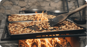 Snacks roasting over an open flame in a small tray